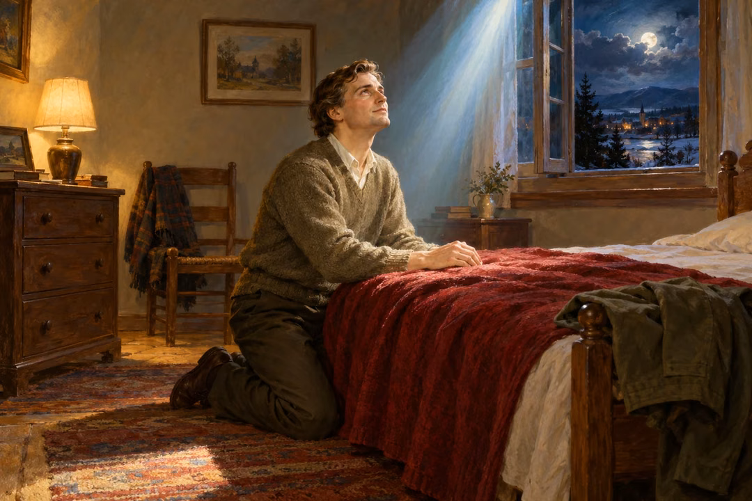 A man kneels in private prayer beside his bed as gentle heavenly light fills the room.