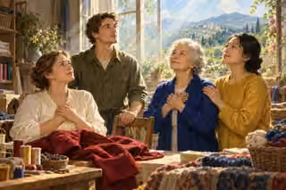 Four neighbors pause together in a sunlit sewing workshop, gazing upward peacefully and supporting one another beside rich folded fabrics.